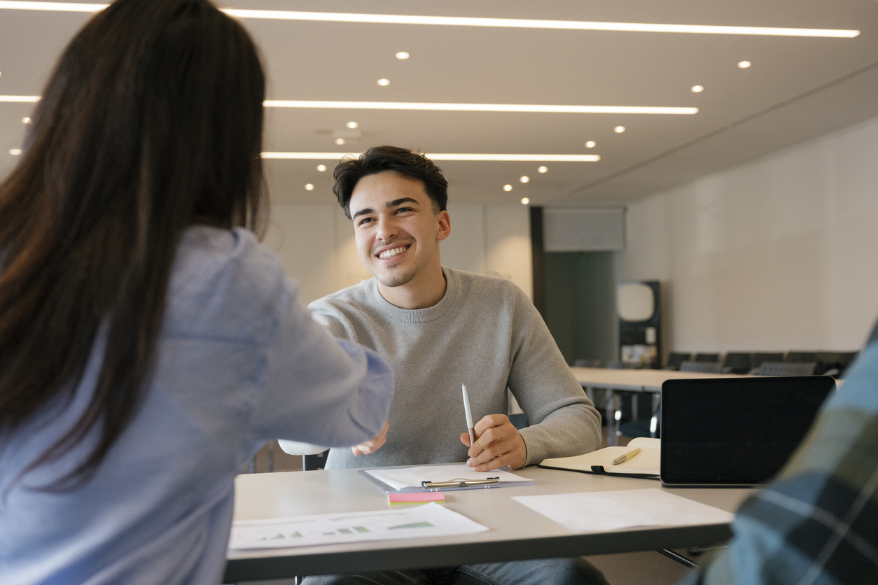 Hiring manager giving job applicant a job skills assessment during the interview