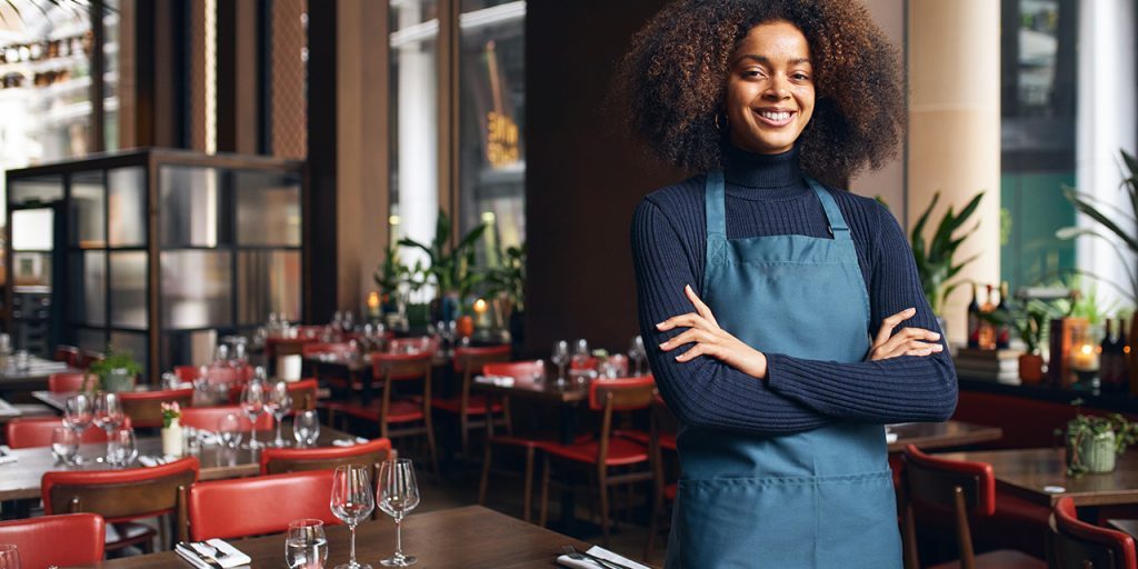 Cheerful small business owner in restaurant